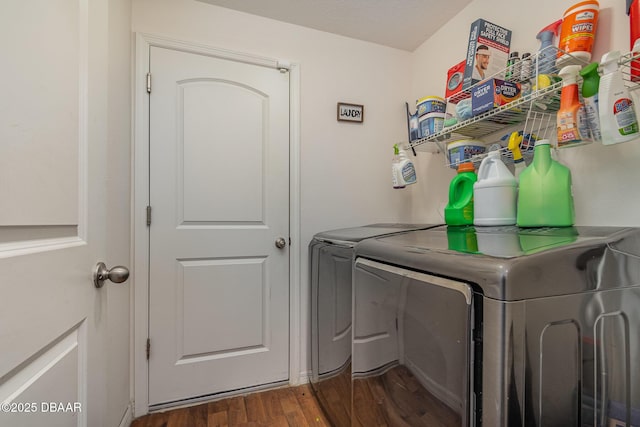 laundry area featuring washing machine and dryer and dark hardwood / wood-style floors