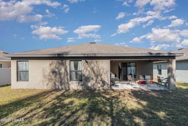 rear view of property with a lawn and a patio