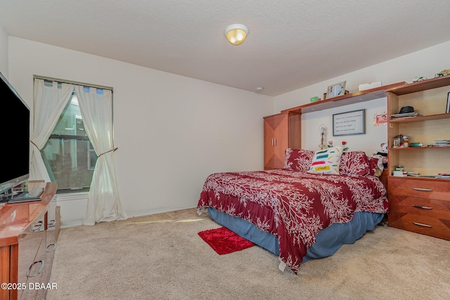 carpeted bedroom featuring a textured ceiling