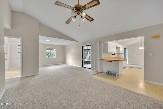 unfurnished living room featuring baseboards, light carpet, high vaulted ceiling, and ceiling fan