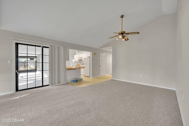 unfurnished living room with light colored carpet, baseboards, a ceiling fan, and vaulted ceiling