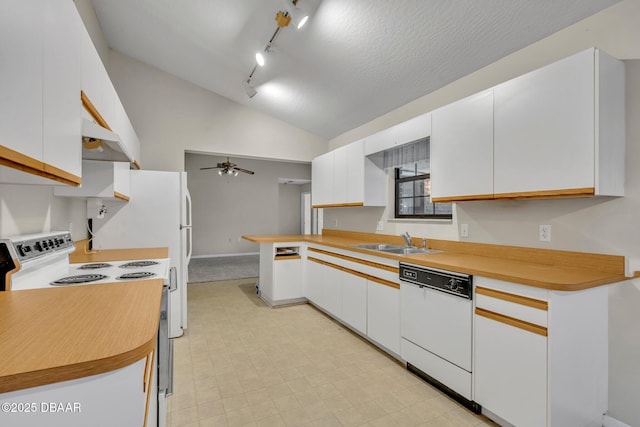 kitchen with vaulted ceiling, white cabinets, white appliances, a ceiling fan, and a sink