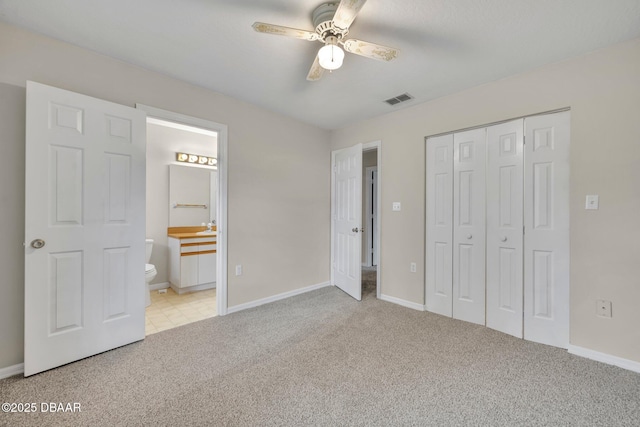 unfurnished bedroom with a closet, visible vents, baseboards, and carpet