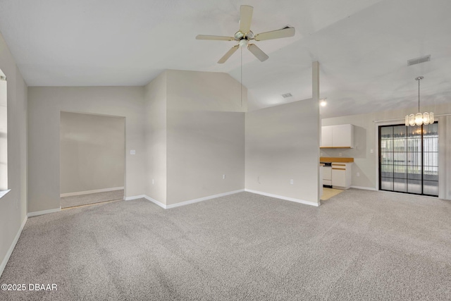 unfurnished living room featuring visible vents, baseboards, vaulted ceiling, light carpet, and ceiling fan with notable chandelier