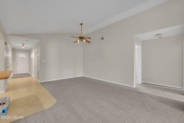 unfurnished living room featuring baseboards, carpet, and vaulted ceiling