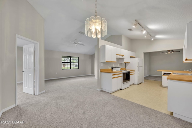 kitchen with visible vents, light carpet, white cabinets, white appliances, and a sink