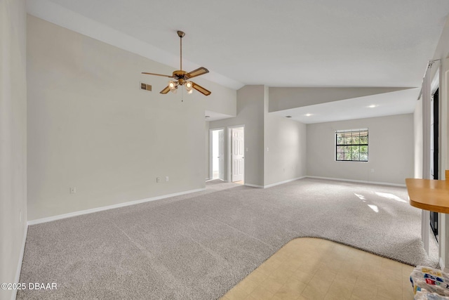 unfurnished living room with baseboards, lofted ceiling, and light colored carpet