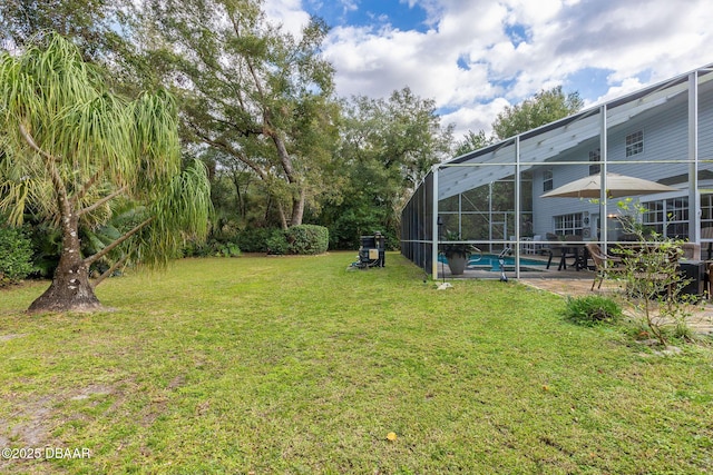 view of yard with a lanai and a patio