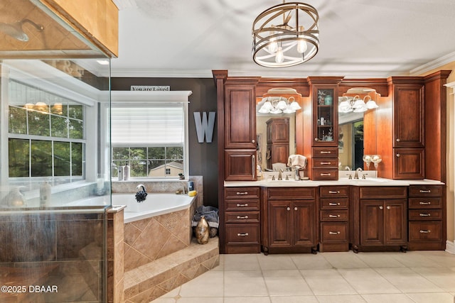 bathroom with an inviting chandelier, tile patterned flooring, tiled bath, vanity, and ornamental molding