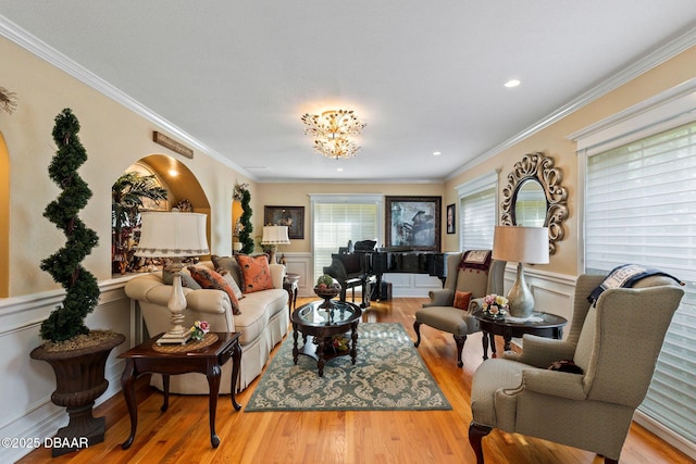 living room with crown molding and light hardwood / wood-style flooring