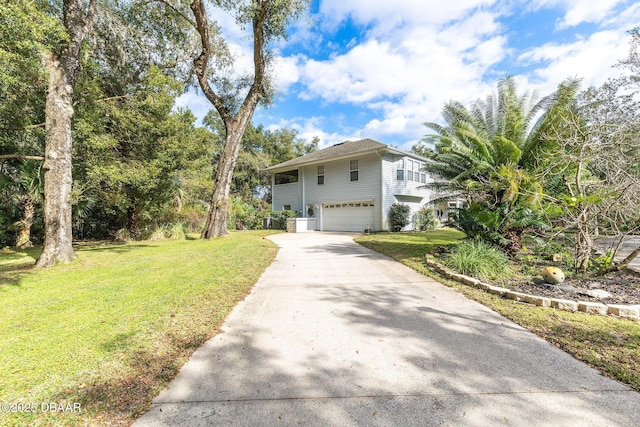 split foyer home featuring a front yard and a garage