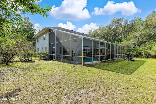 back of house featuring a lanai and a lawn