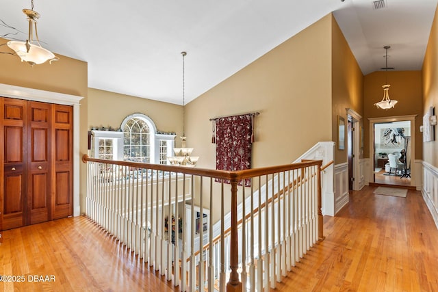 hall featuring light hardwood / wood-style floors and lofted ceiling