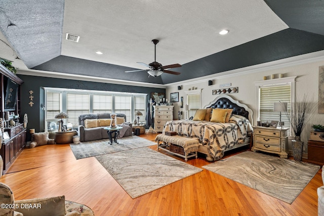 bedroom featuring a textured ceiling, vaulted ceiling, ceiling fan, and crown molding