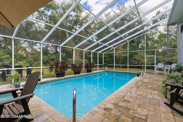 view of swimming pool with a patio and glass enclosure