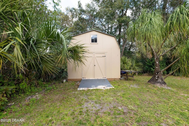 view of outdoor structure featuring a lawn