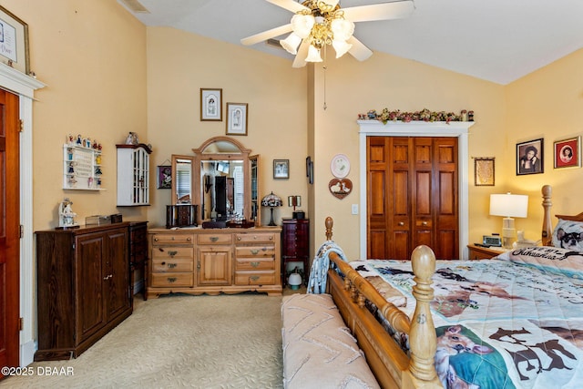 bedroom with a closet, ceiling fan, lofted ceiling, and light colored carpet