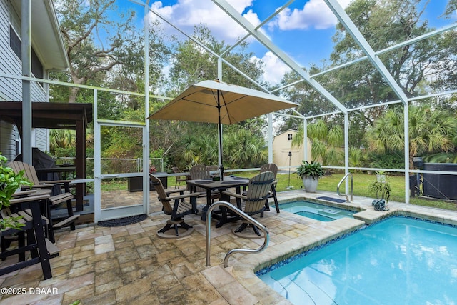 view of swimming pool featuring glass enclosure, an in ground hot tub, a patio, and a shed