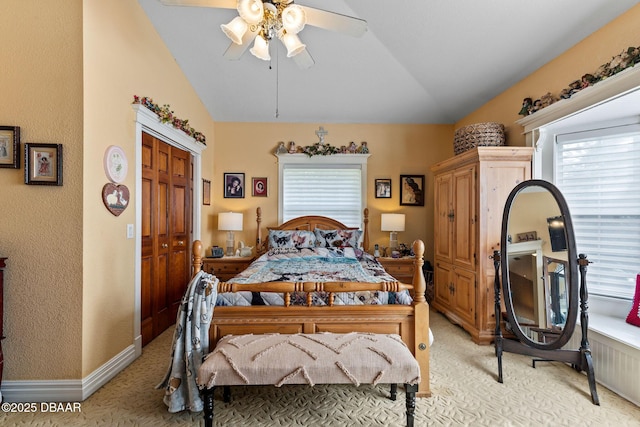 carpeted bedroom featuring ceiling fan, lofted ceiling, and a closet