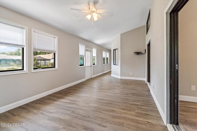 unfurnished room with wood-type flooring and ceiling fan