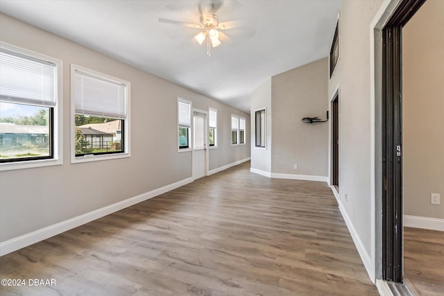 10 Falls Pl, Palm Coast, FL 32137 - empty room with a ceiling fan, wood finished floors, baseboards, and vaulted ceiling