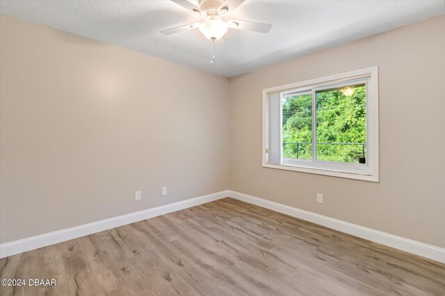 unfurnished room featuring ceiling fan and light hardwood / wood-style floors