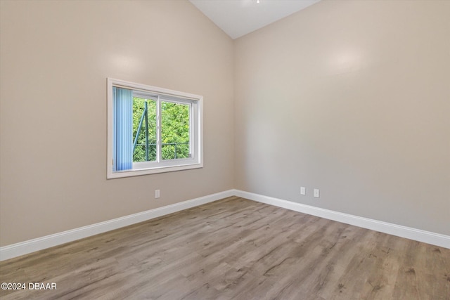 10 Falls Pl, Palm Coast, FL 32137 - spare room featuring wood finished floors, baseboards, and high vaulted ceiling