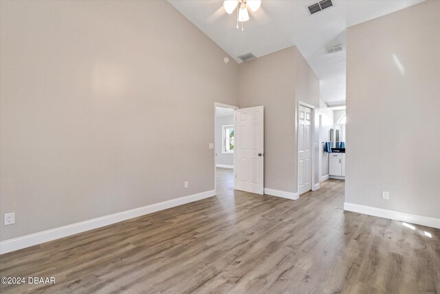 unfurnished room featuring ceiling fan, light hardwood / wood-style flooring, and high vaulted ceiling