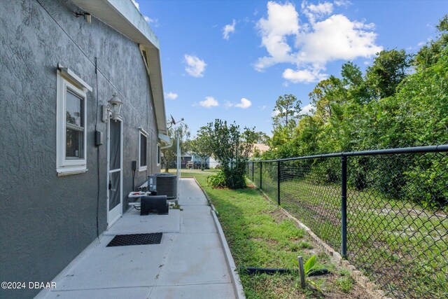 view of home's exterior featuring central air condition unit, a yard, and a patio area