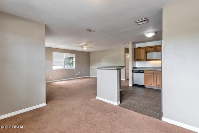 kitchen featuring stainless steel dishwasher, ceiling fan, dark colored carpet, and sink