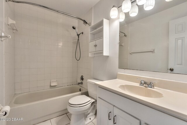 full bathroom featuring toilet, vanity, tiled shower / bath, and tile patterned flooring