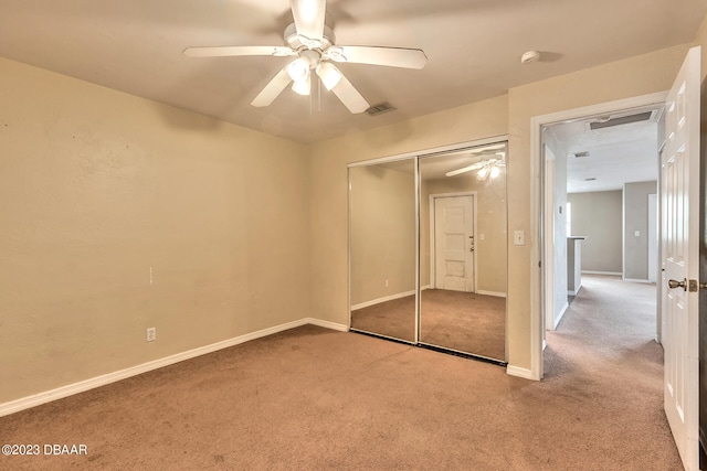 unfurnished bedroom with carpet, ceiling fan, and a closet