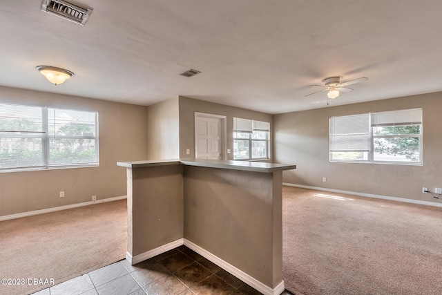 spare room featuring carpet and ceiling fan