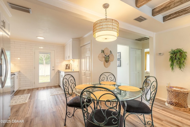 92 S Orchard St, Ormond Beach, FL 32174 - dining space with light wood-type flooring, ornamental molding, and beamed ceiling