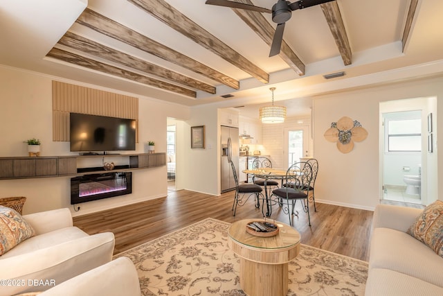 92 S Orchard St, Ormond Beach, FL 32174 - living area with a ceiling fan, wood finished floors, healthy amount of natural light, beam ceiling, and baseboards