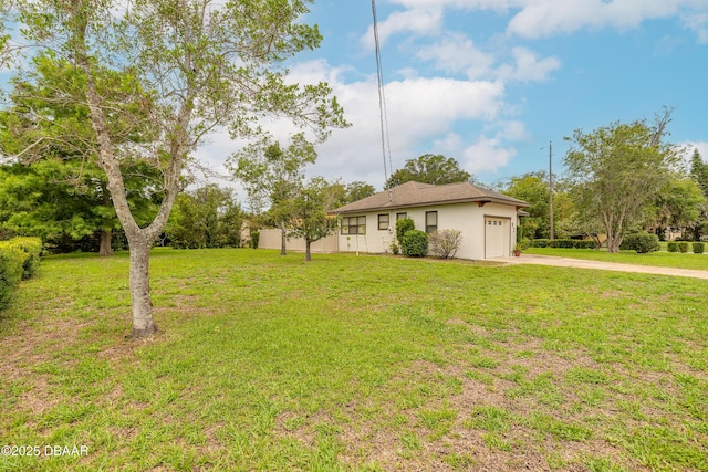 92 S Orchard St, Ormond Beach, FL 32174 - view of green lawn featuring a garage and concrete driveway