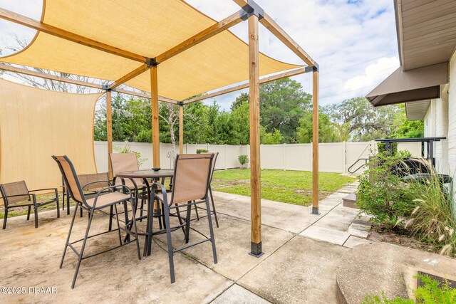 92 S Orchard St, Ormond Beach, FL 32174 - fenced backyard featuring outdoor dining area and a patio area