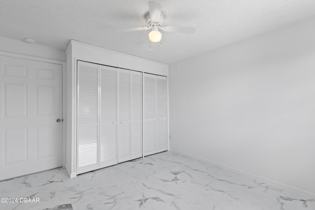 unfurnished bedroom with a closet, a textured ceiling, and ceiling fan