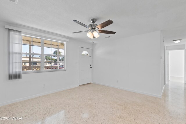 spare room with a textured ceiling and ceiling fan