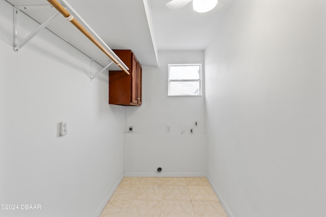 washroom featuring cabinets, hookup for a washing machine, hookup for an electric dryer, and light tile patterned floors