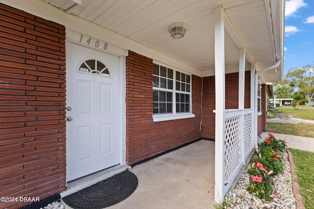 view of exterior entry with a porch