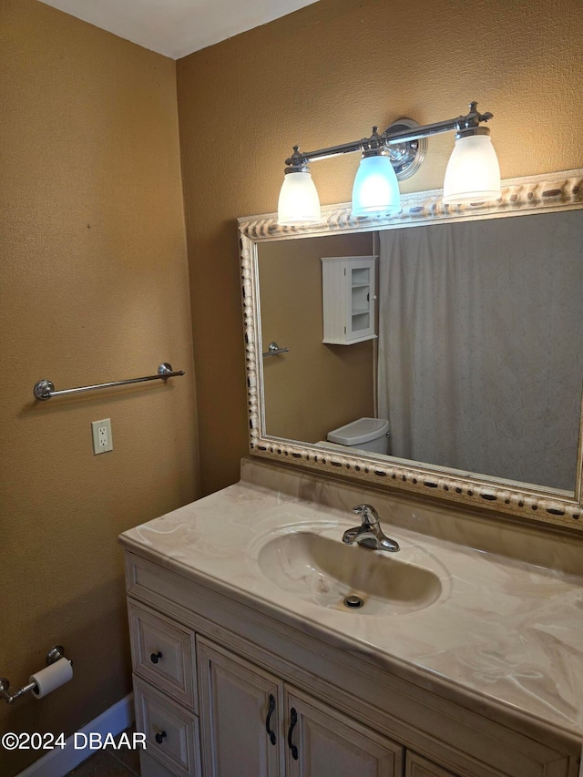 bathroom with toilet and vanity