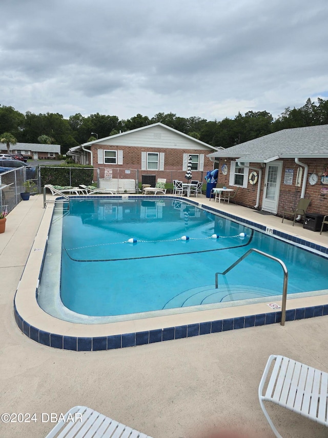 view of swimming pool with a patio