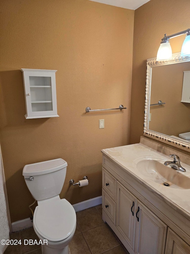 bathroom featuring vanity, tile patterned flooring, and toilet