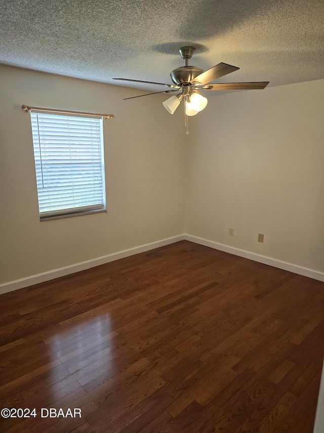 spare room featuring ceiling fan, a textured ceiling, and dark hardwood / wood-style flooring