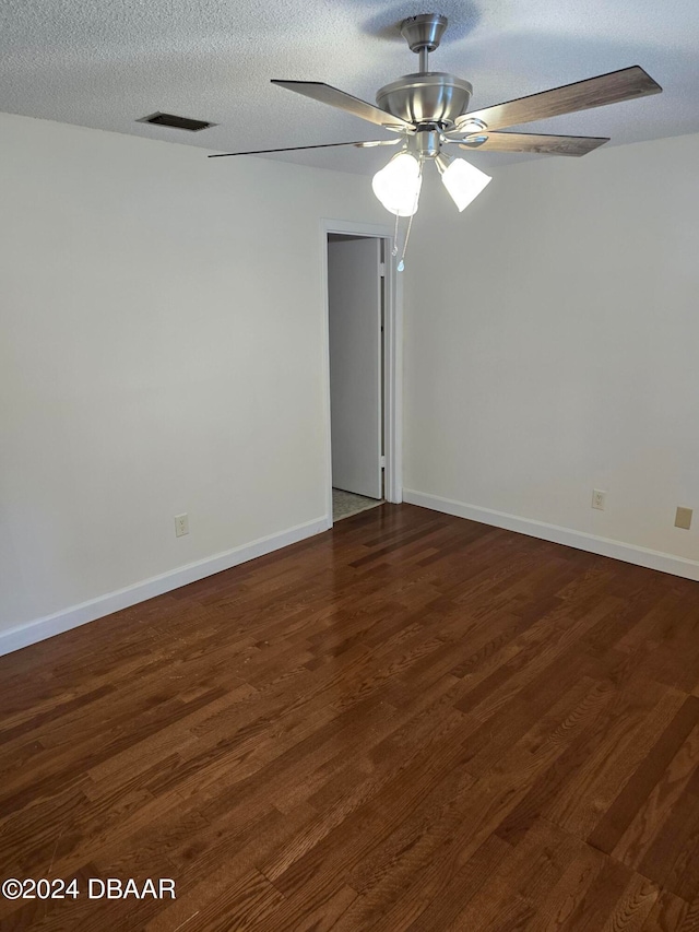 unfurnished room featuring a textured ceiling, ceiling fan, and dark hardwood / wood-style floors