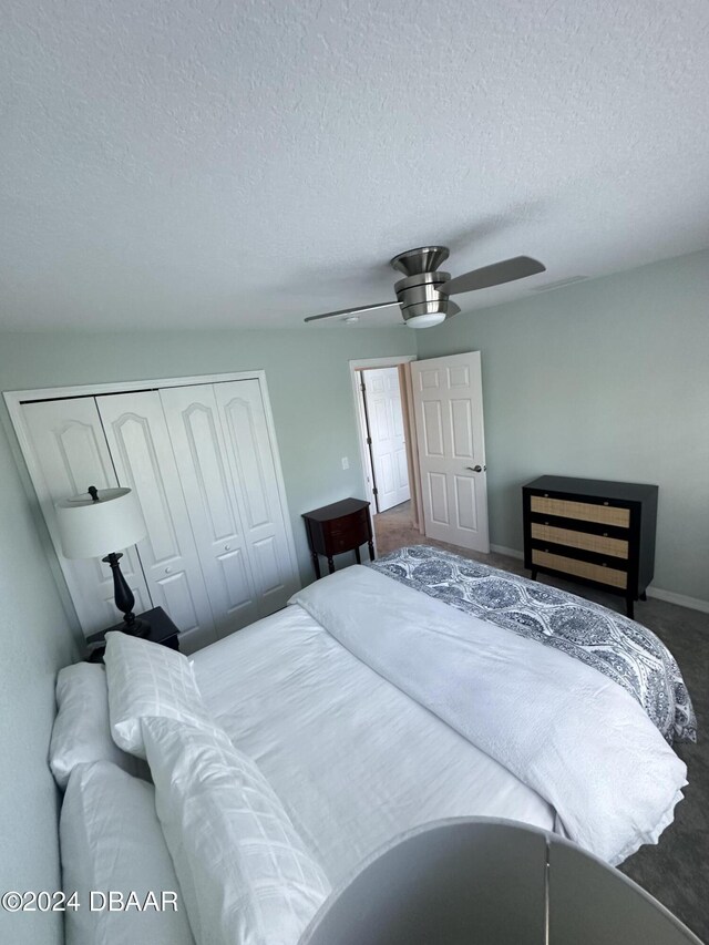 1021 Alabama Ave, Holly Hill, FL 32117 - bedroom with a closet, a textured ceiling, carpet floors, ceiling fan, and baseboards