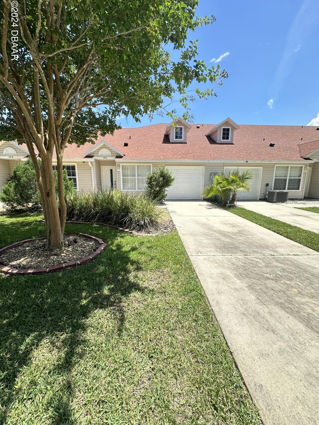 1021 Alabama Ave, Holly Hill, FL 32117 - single story home featuring driveway, an attached garage, and a front yard
