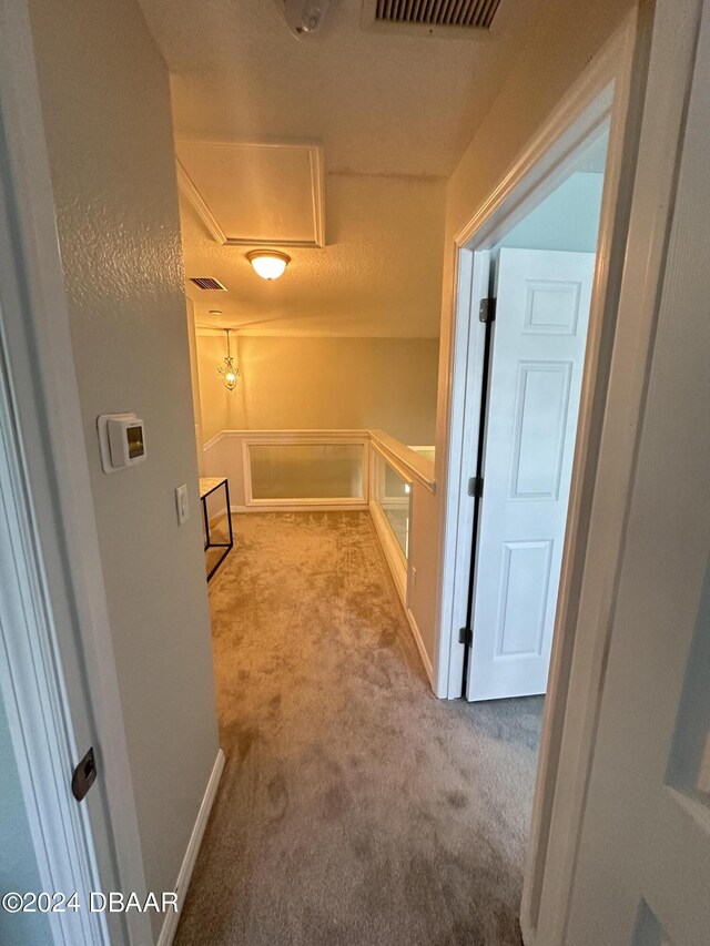1021 Alabama Ave, Holly Hill, FL 32117 - corridor featuring carpet flooring, an upstairs landing, and baseboards