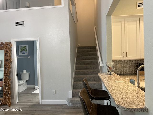 1021 Alabama Ave, Holly Hill, FL 32117 - staircase featuring wood finished floors and baseboards